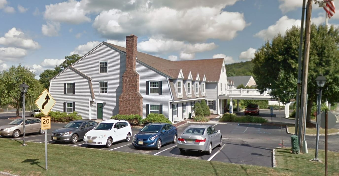 Exterior view of Colonial Manor with parking lot