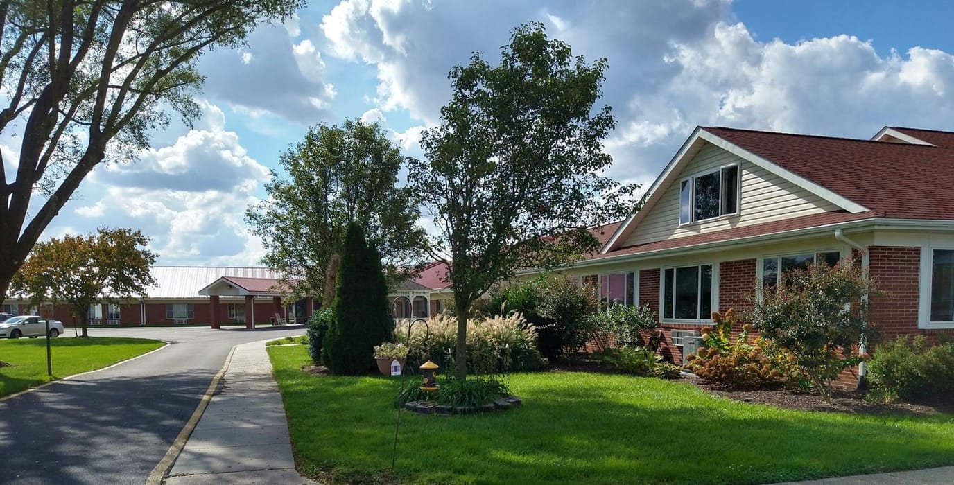 Exterior view of the Country Rest Home facility with gardens