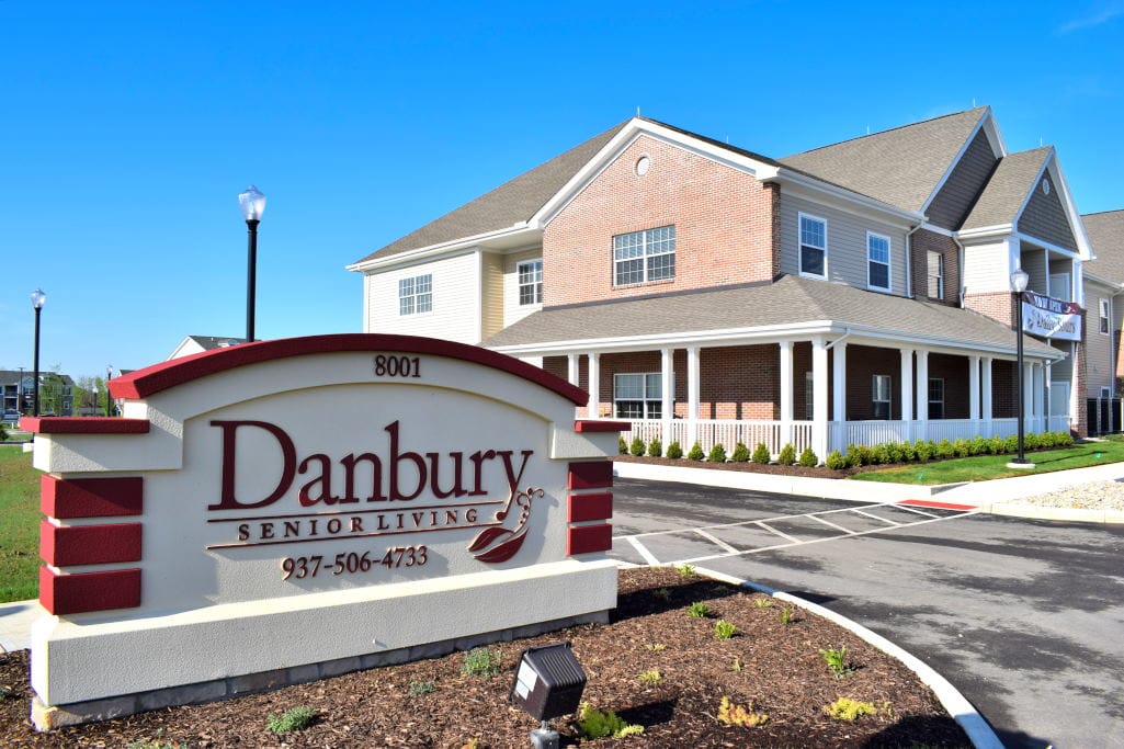 Exterior view of Danbury Senior Living building with sign