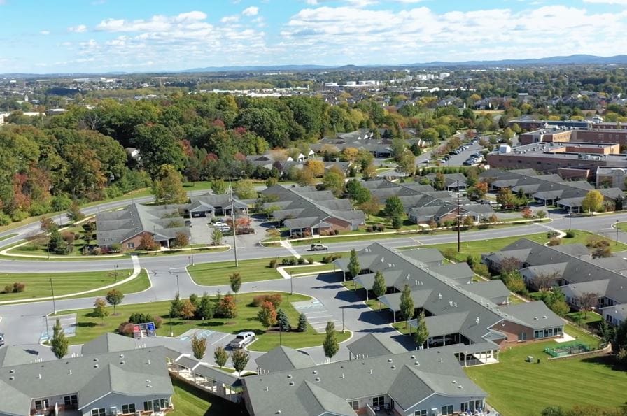 Aerial view of a senior living community with landscaped grounds