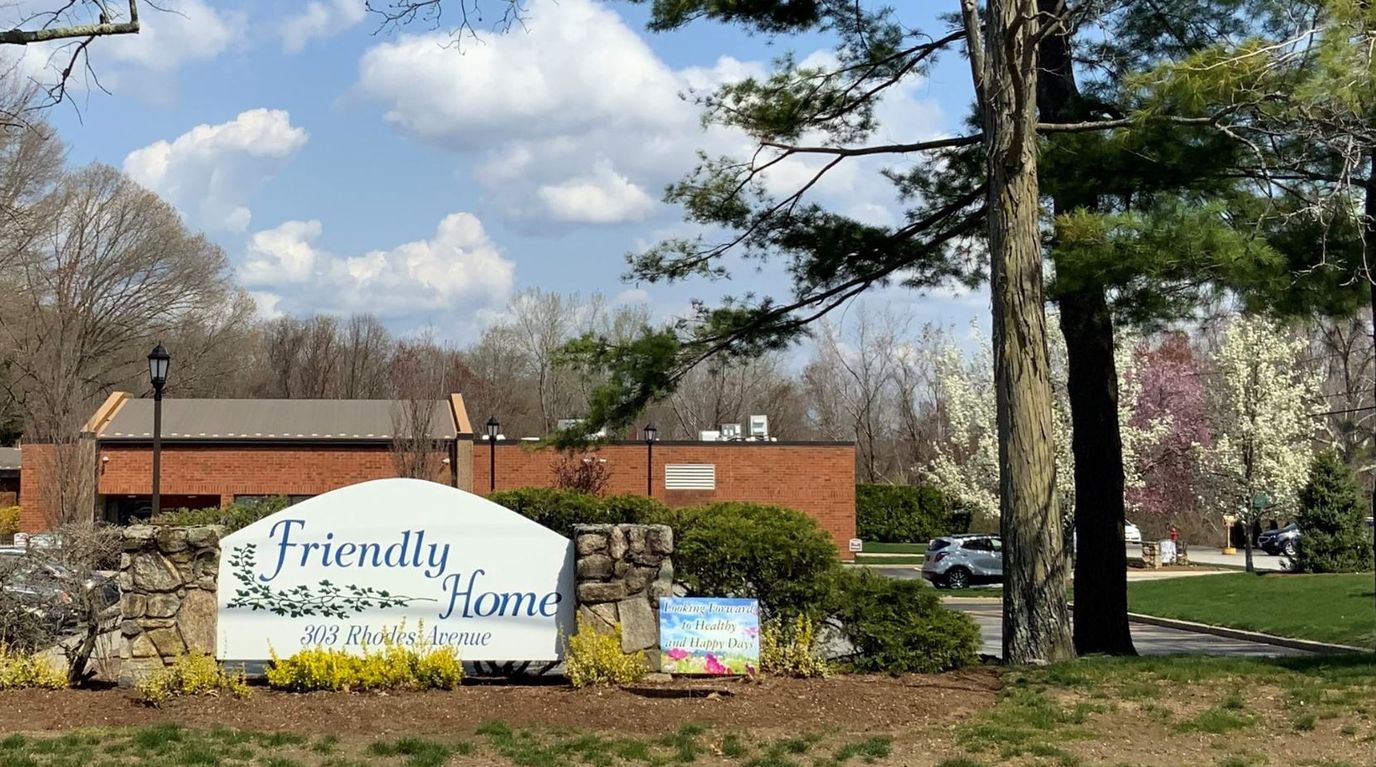 Exterior view of the Friendly Home facility and sign