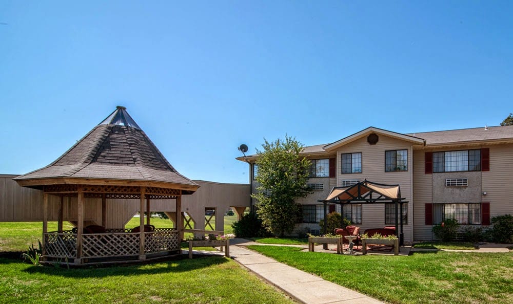 Exterior view of a senior living facility with a gazebo