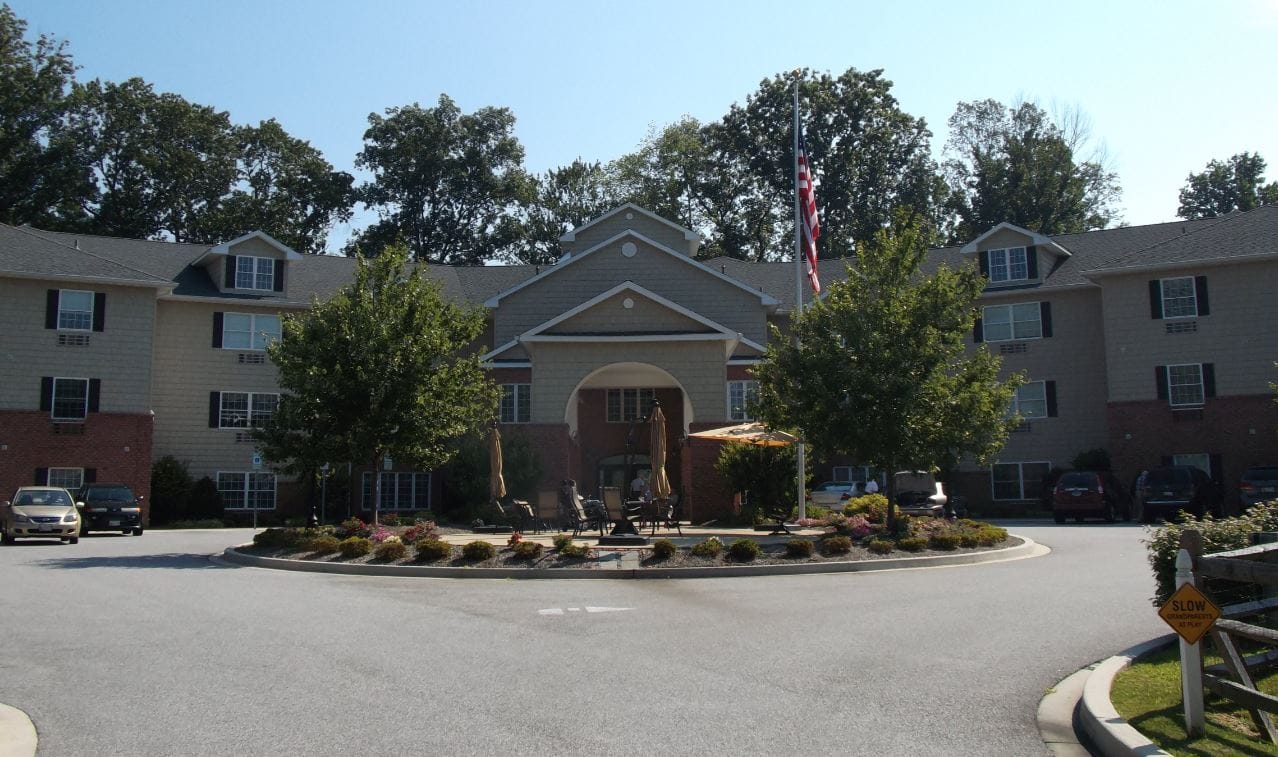 Exterior view of Hart Heritage Estates with trees and flag