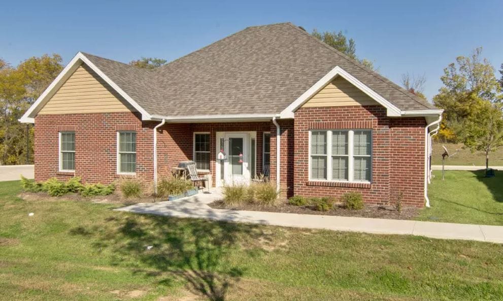 Exterior view of a senior living facility with landscaped entrance