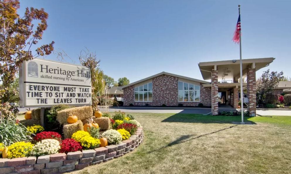 Exterior view of Heritage Hall with flowers and signage