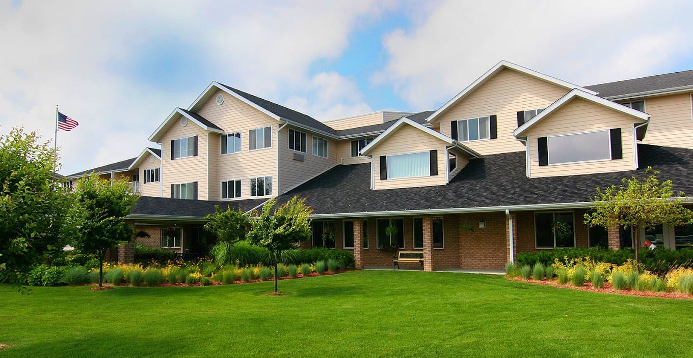 Exterior view of assisted living facility with landscaped lawn