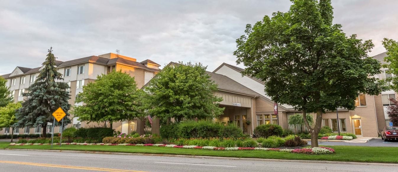 Exterior view of Independence Village of Plymouth surrounded by greenery