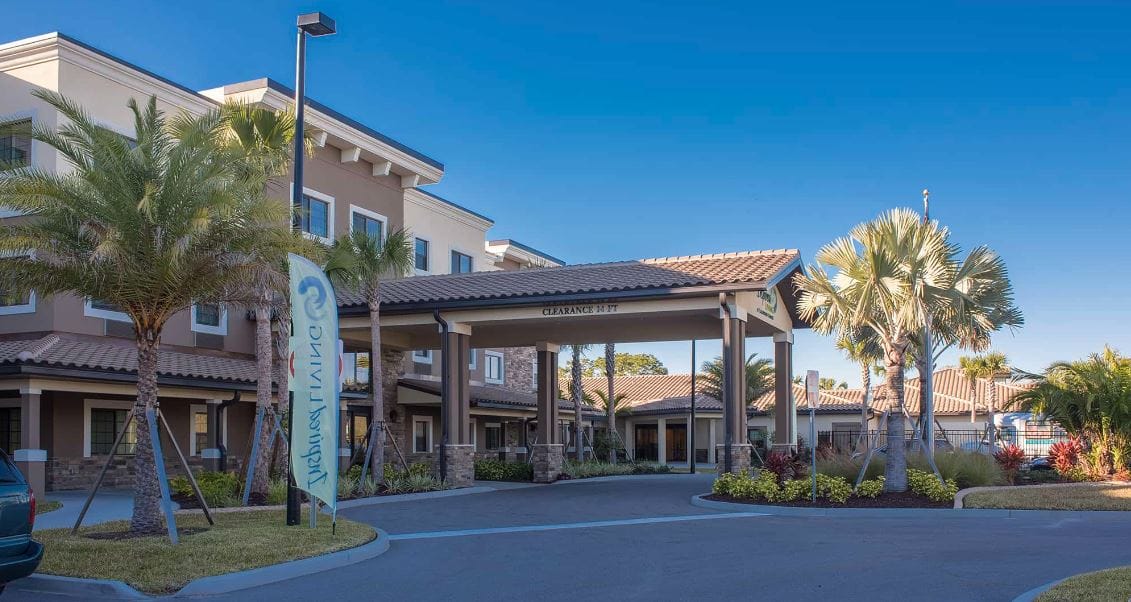 View of the facility building with palm trees
