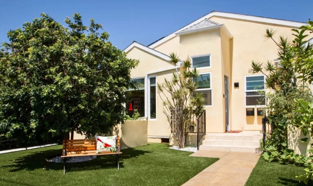 Exterior view of a senior living facility with garden