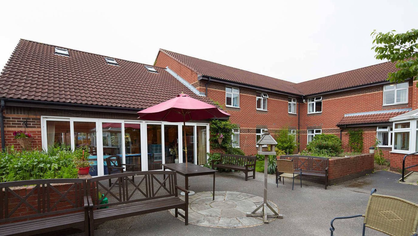 Outdoor area with benches and a patio umbrella