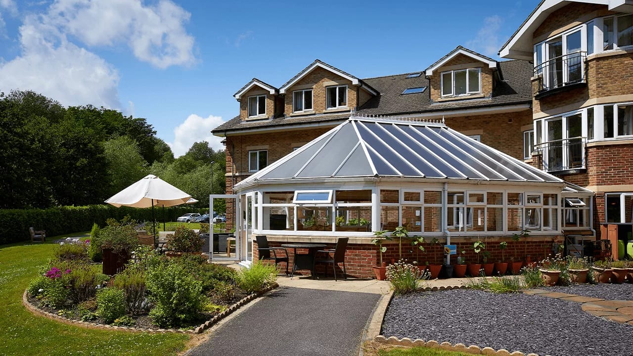A beautiful outdoor space with a sunroom and garden