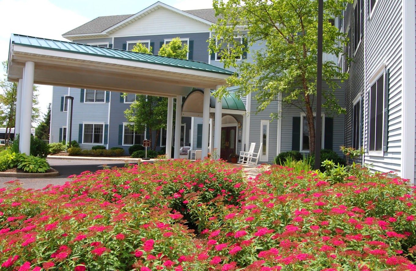 Exterior view of a nursing home entrance with flowers