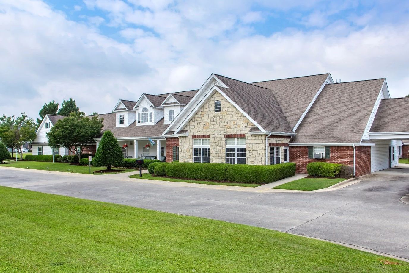 Exterior view of a senior living facility with landscaping