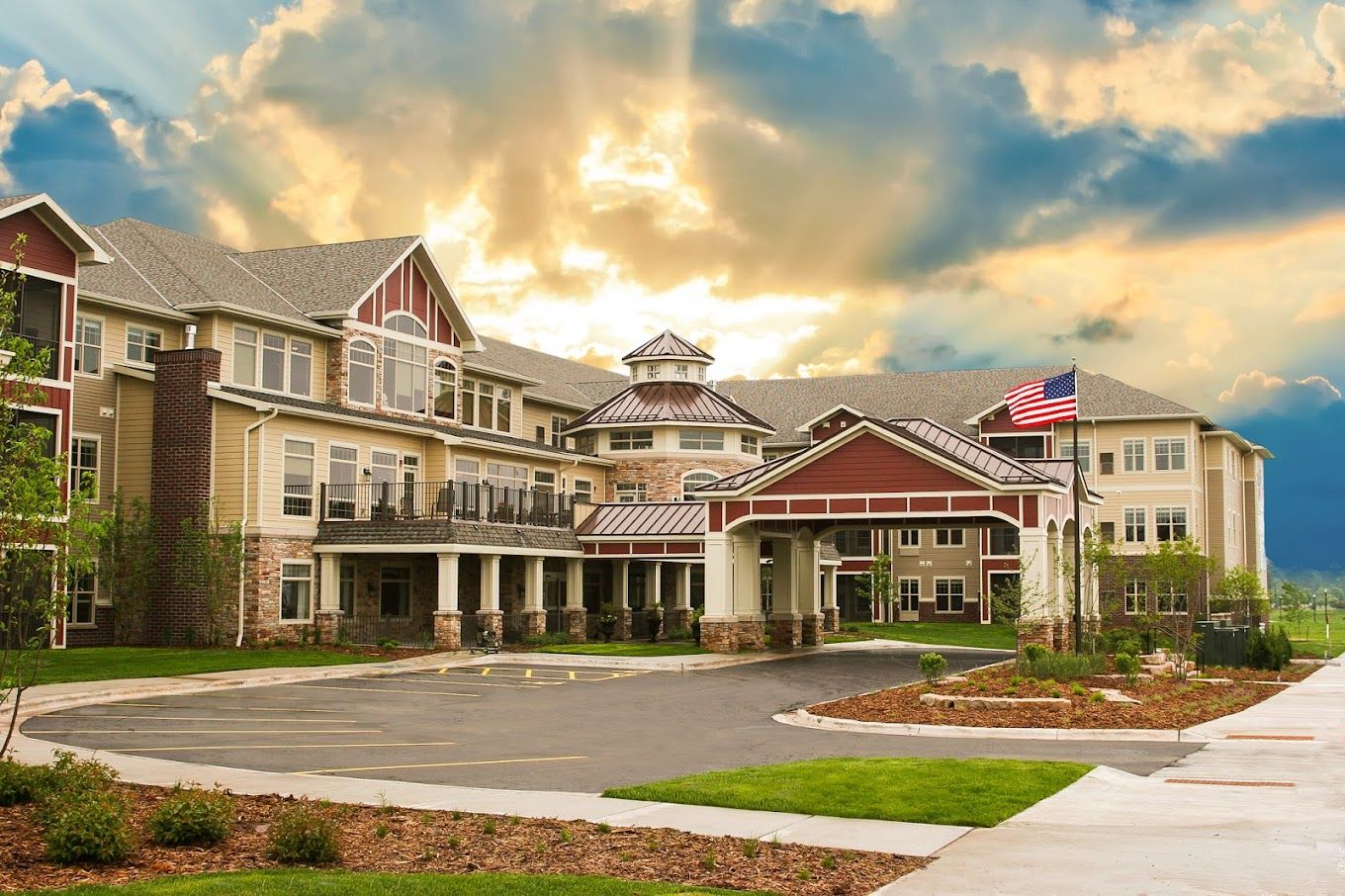 Building exterior of a senior living facility with a flag