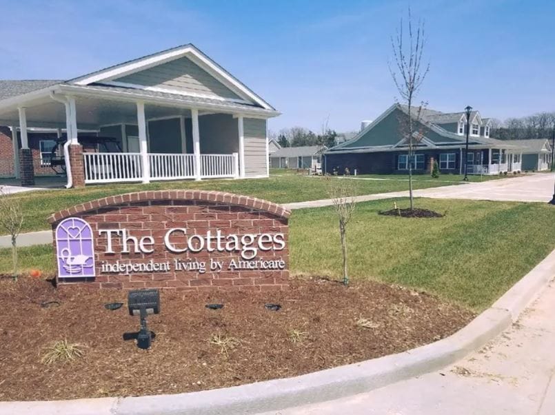 Exterior view of The Cottages facility with signage