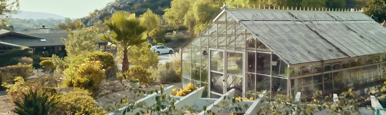 View of a greenhouse and surrounding gardens at the facility
