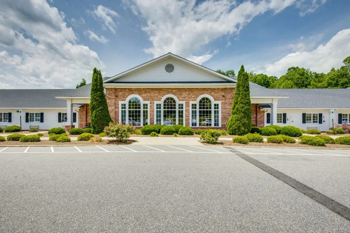 Exterior view of Priddy Manor with garden and parking area