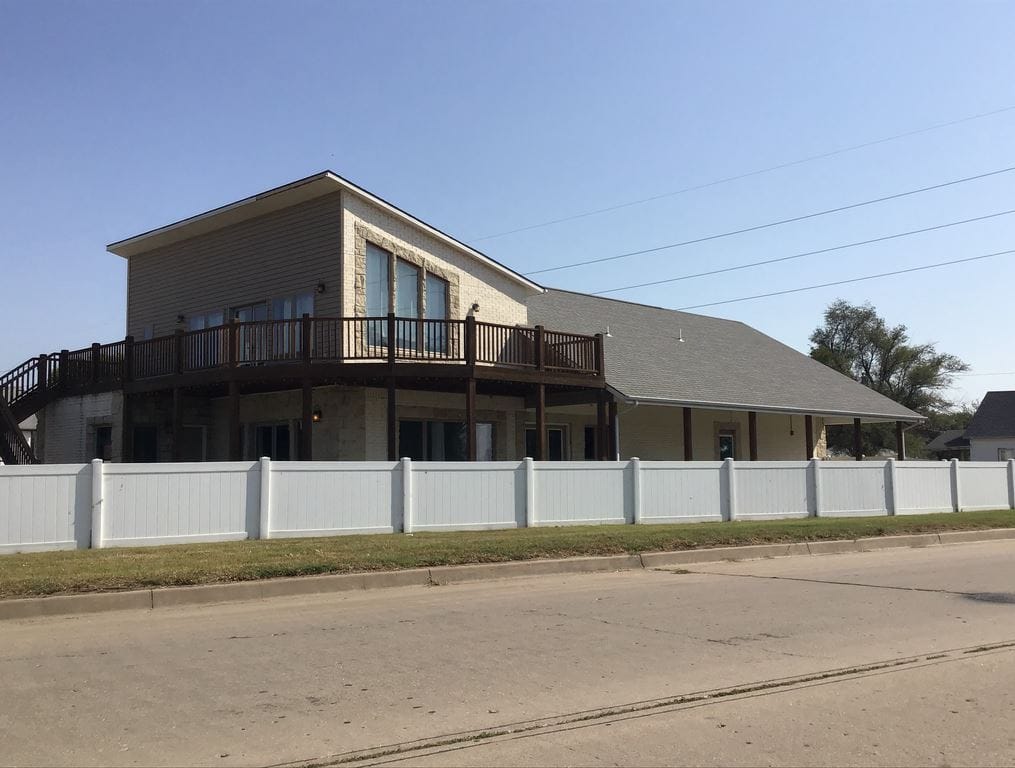 Exterior view of a nursing home building with a fence