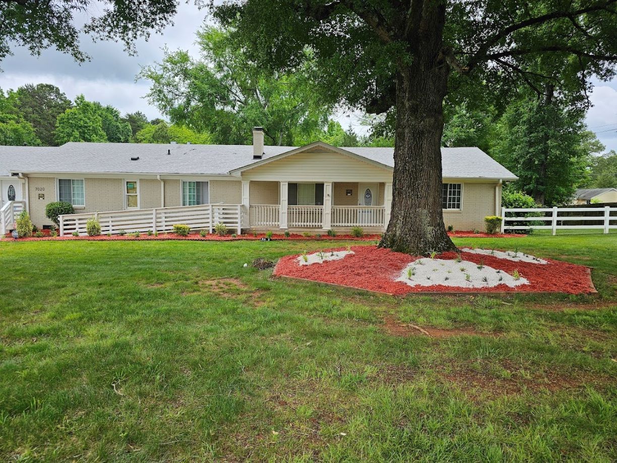 Exterior view of a senior living facility with landscaping