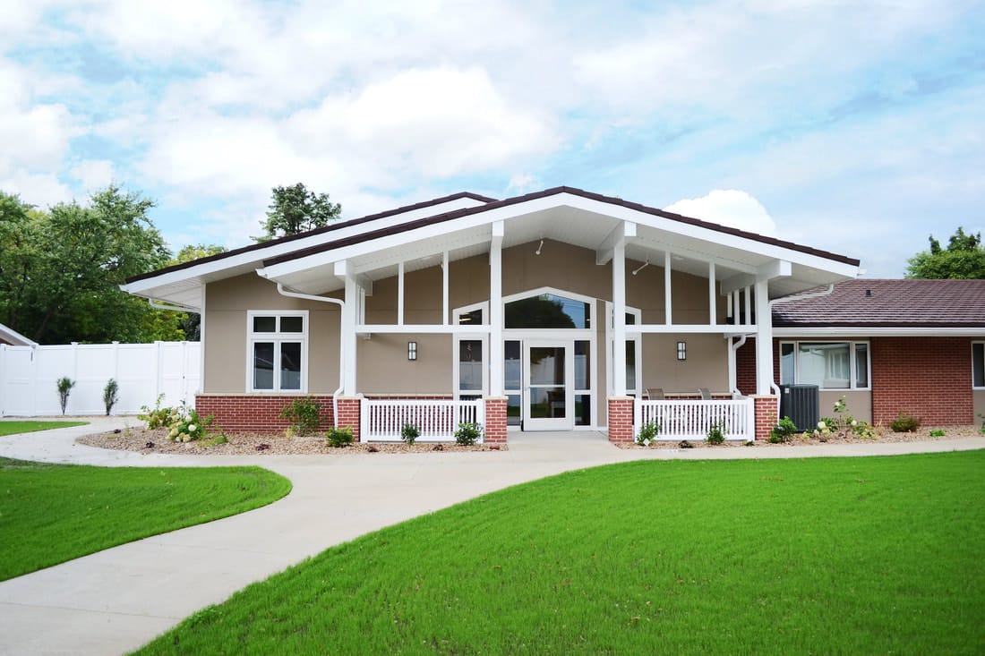Modern exterior of a senior living facility with landscaped grounds