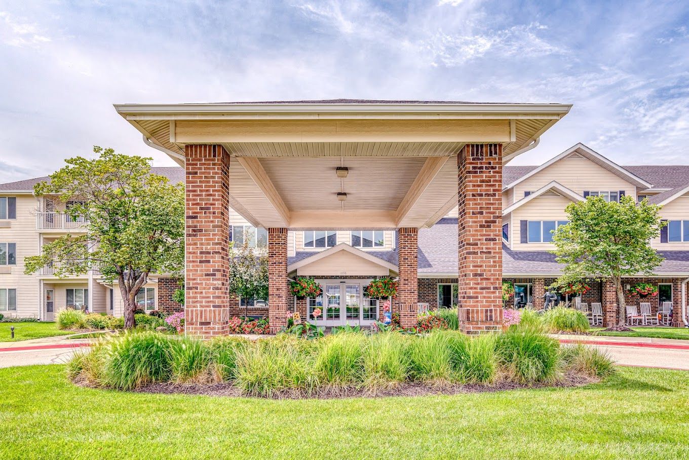 Entrance of Solstice Senior Living with flowers and greenery