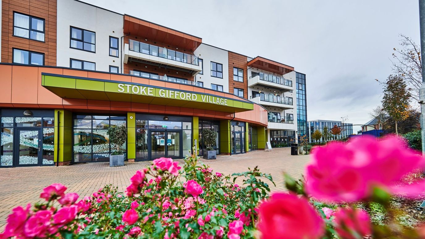 Exterior view of Stoke Gifford Village with colorful flowers