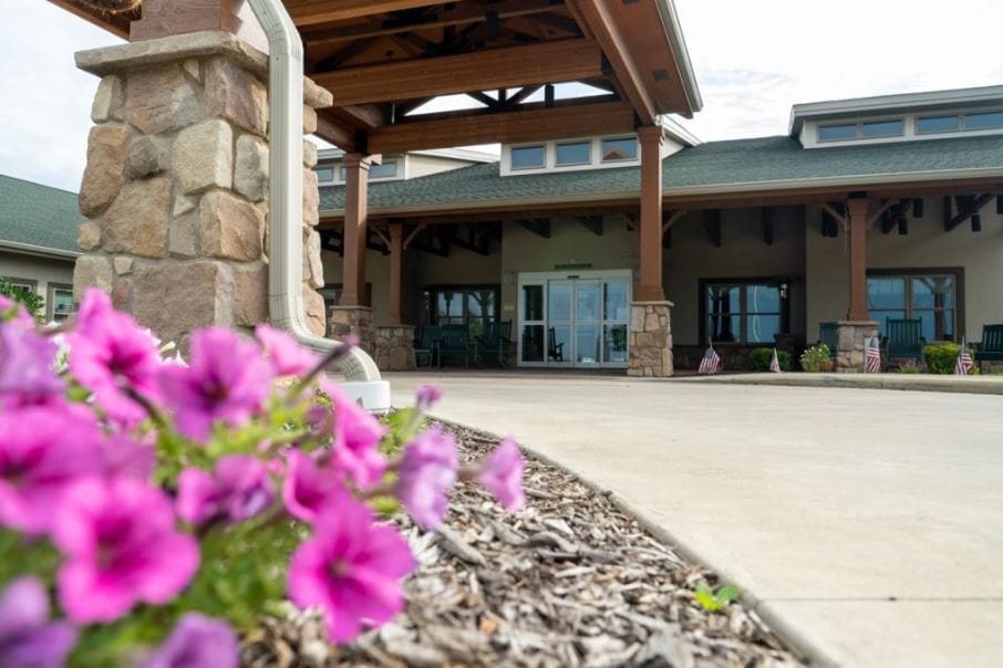 View of the facility entrance with flowers in foreground