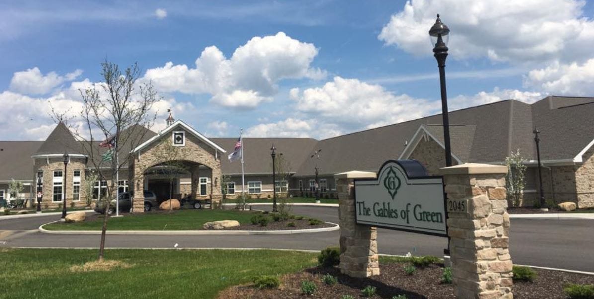 Exterior view of The Gables of Green facility with signage
