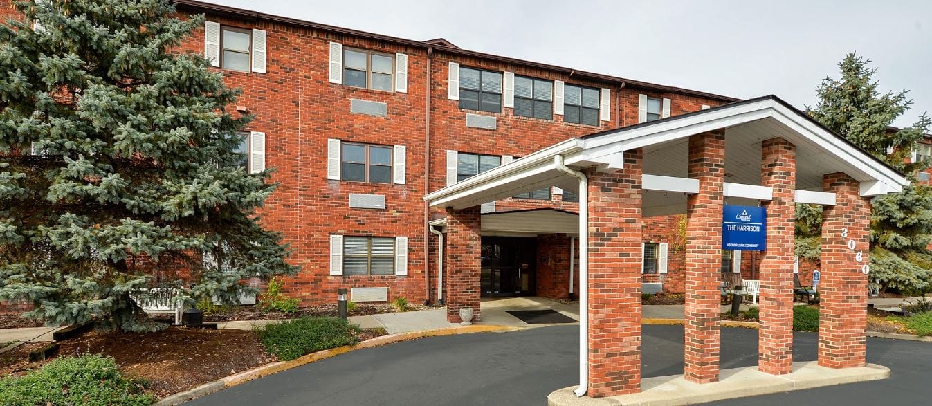 Exterior view of The Harrison senior living facility entrance