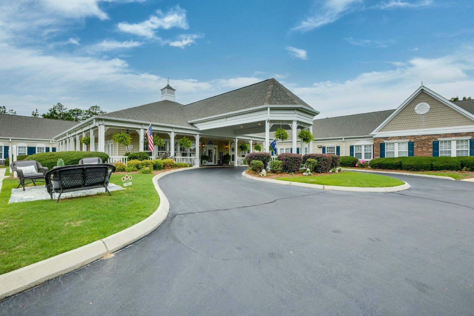 Exterior entrance of a senior living facility with landscaping