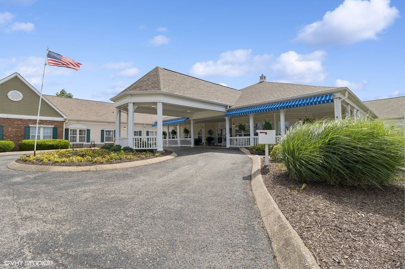 Entrance of The Neighborhood at Hopkinsville with flag and landscaping