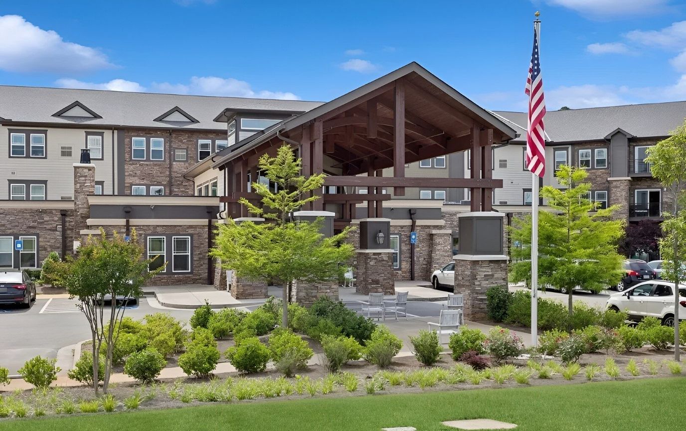 Exterior view of a senior living facility with landscaped gardens