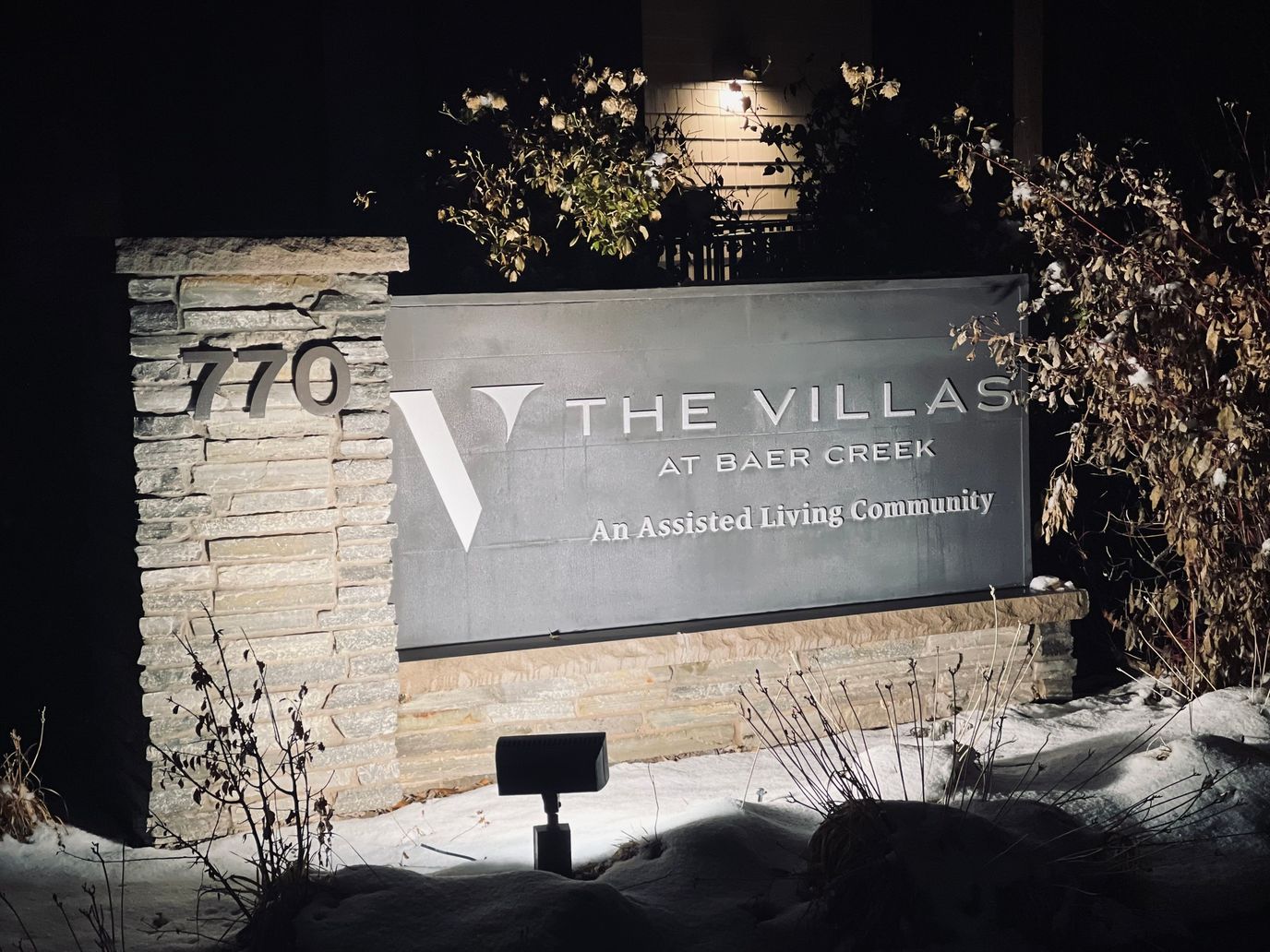 Signage for The Villas at Baer Creek illuminated at night