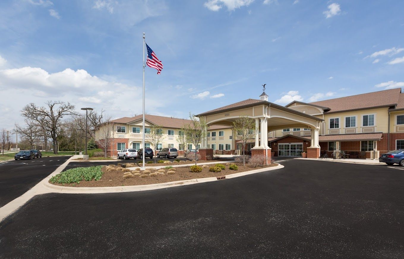 Exterior view of Three Oaks Assisted Living facility with landscaping