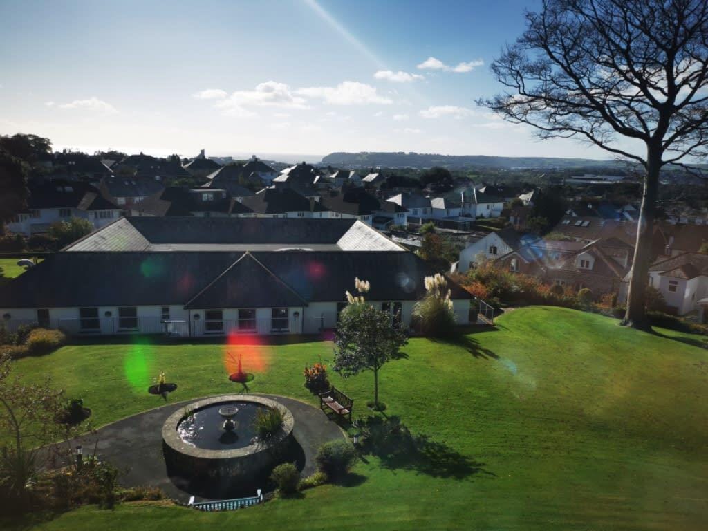 Aerial view of the facility surrounded by landscaped gardens