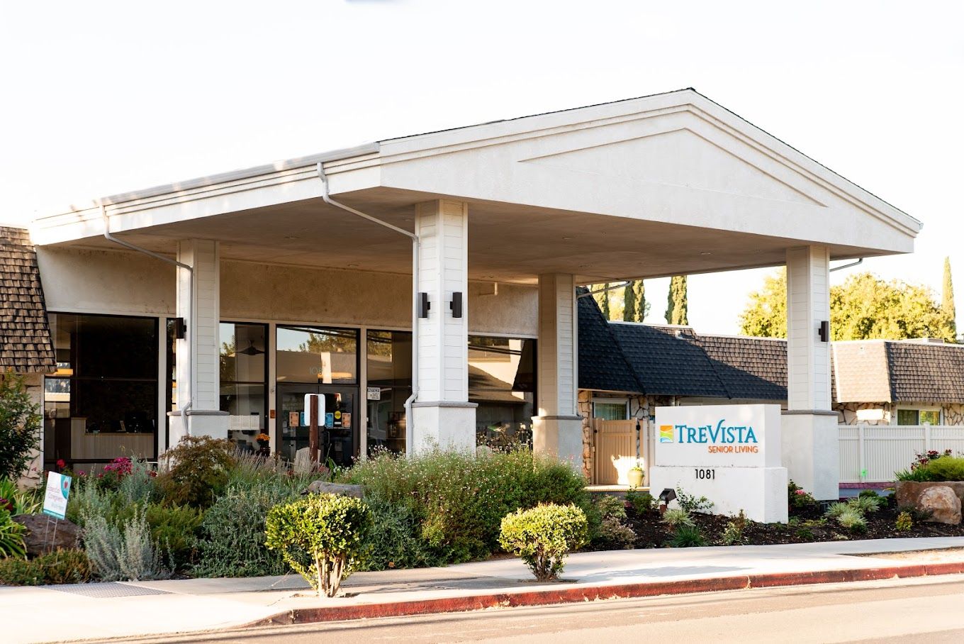 Exterior view of TreVista Senior Living building with landscaping