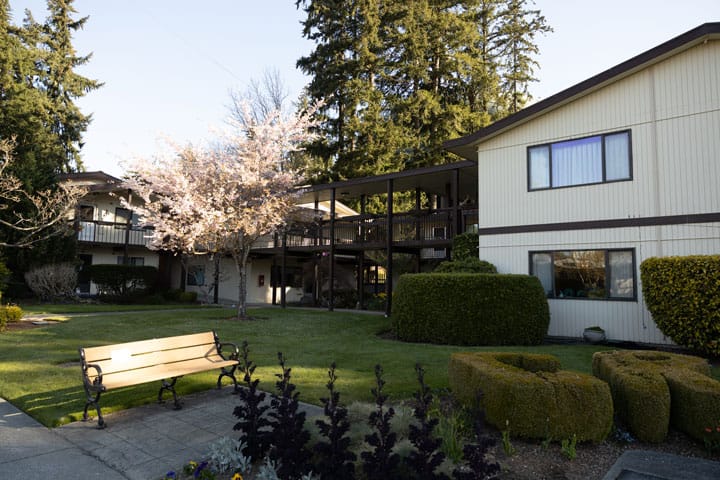Exterior view of assisted living facility with garden