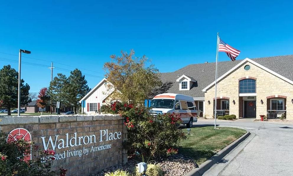 Exterior view of Waldron Place Senior Living facility with van