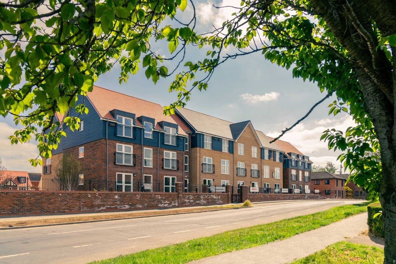 Exterior view of a senior living facility with greenery