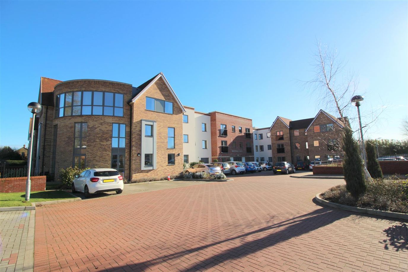 Exterior view of Westonia Court with parked cars