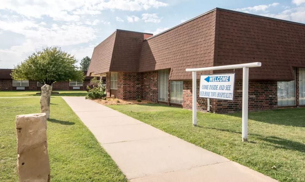 Exterior view of Wheatland Nursing Center with welcome sign