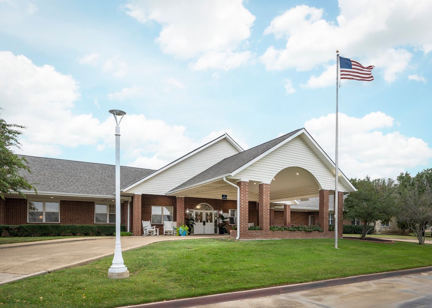 Exterior view of Whitley Place with flag and landscaping