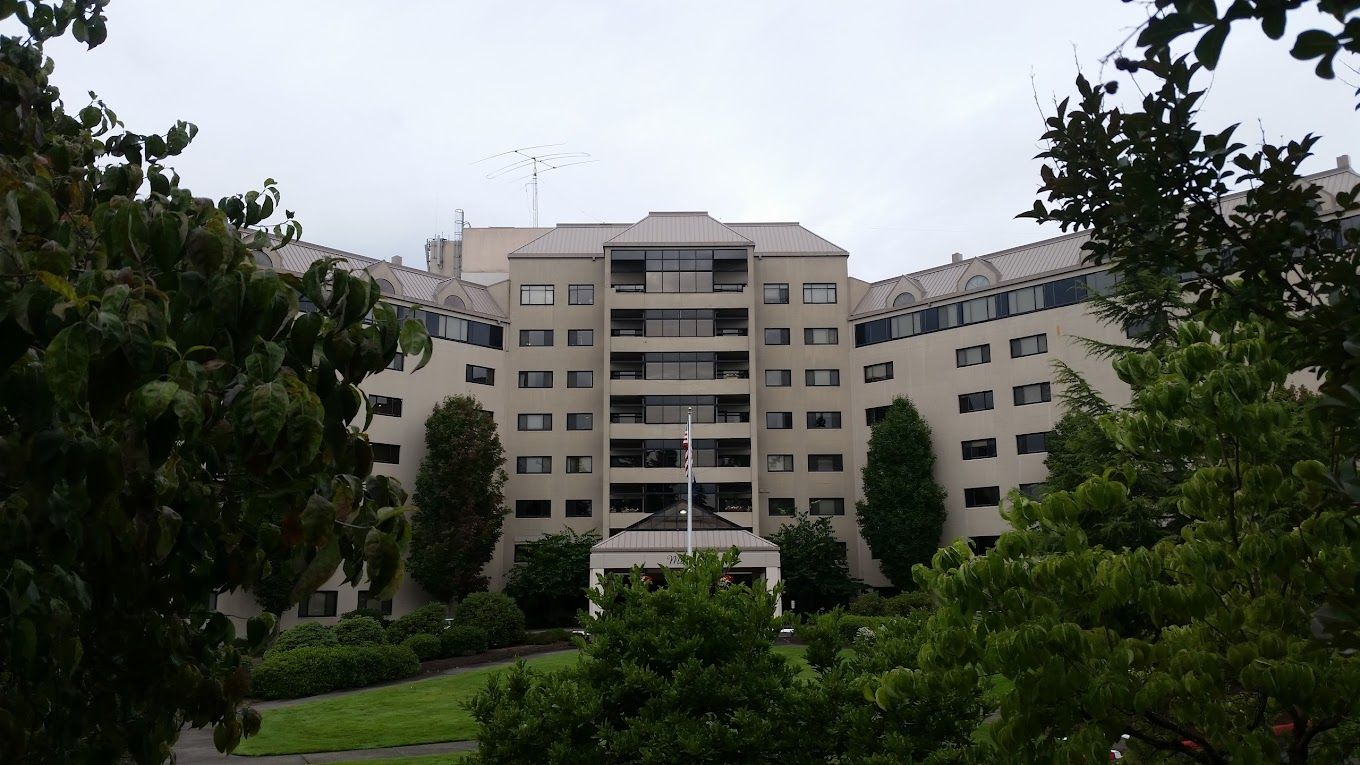 Exterior view of Willamette View facility surrounded by greenery