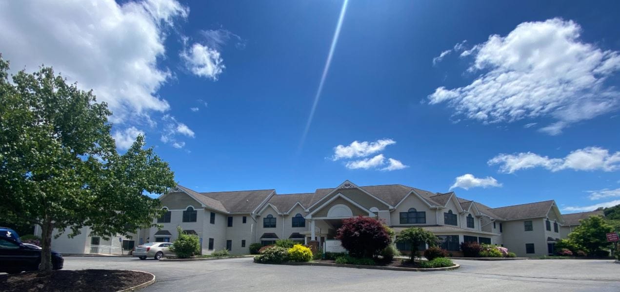 Exterior view of Willowbrook Place with gardens.