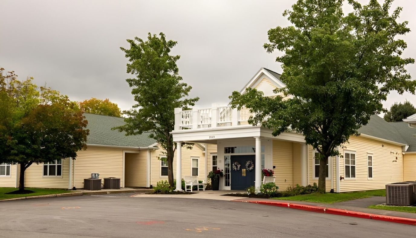 Exterior view of a senior living facility with gardens
