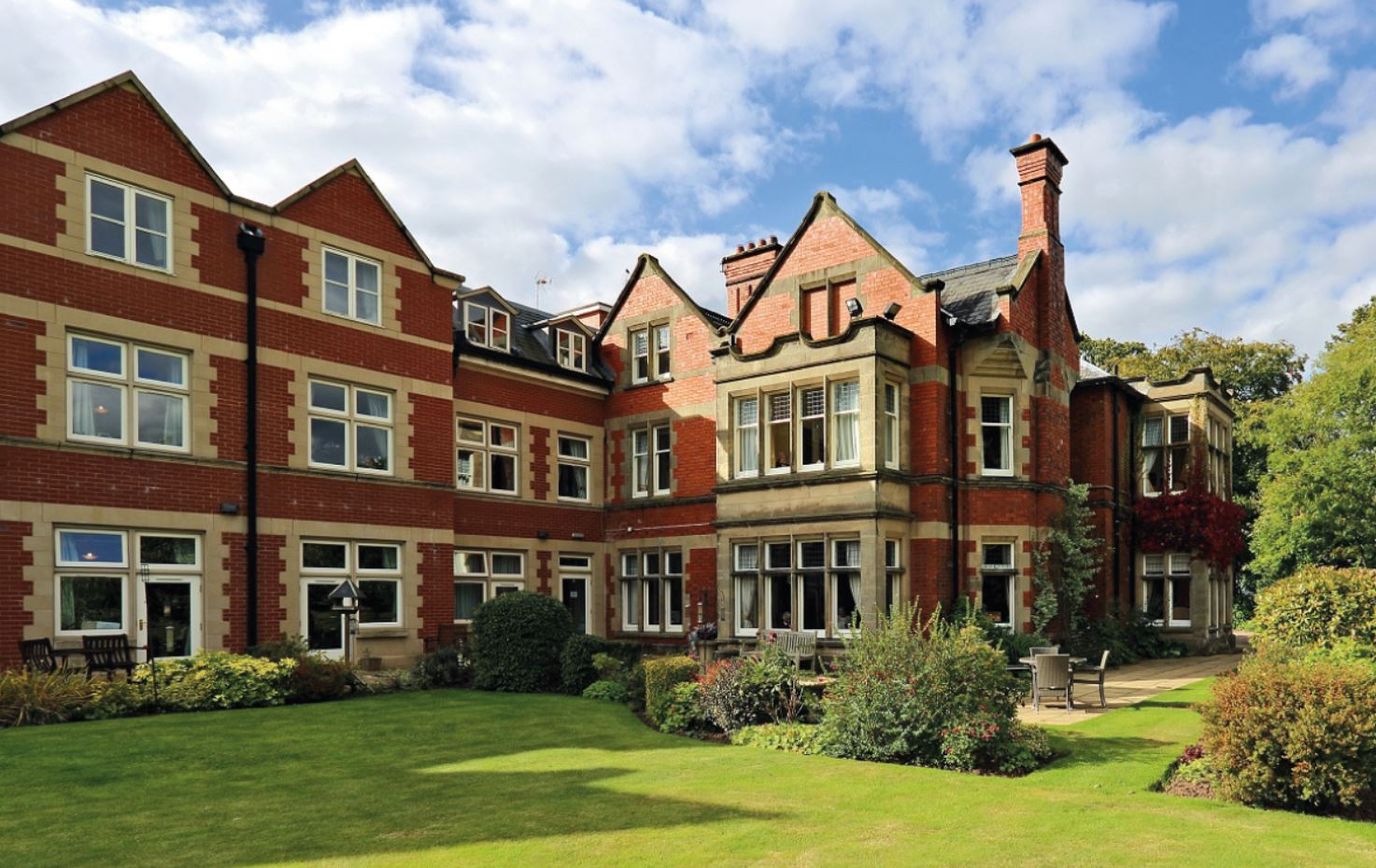 Exterior view of a nursing home building and garden