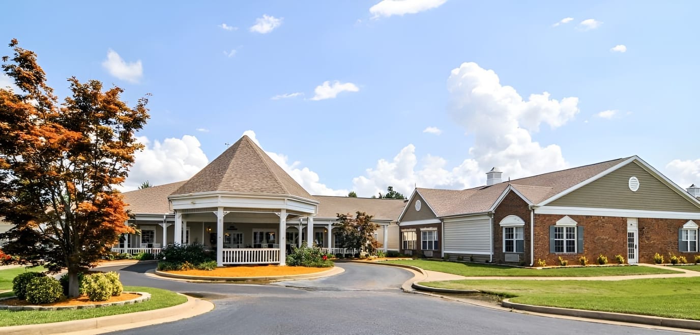 Exterior view of a senior living facility with landscaping