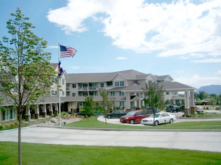 Exterior view of the building with flag and landscaping