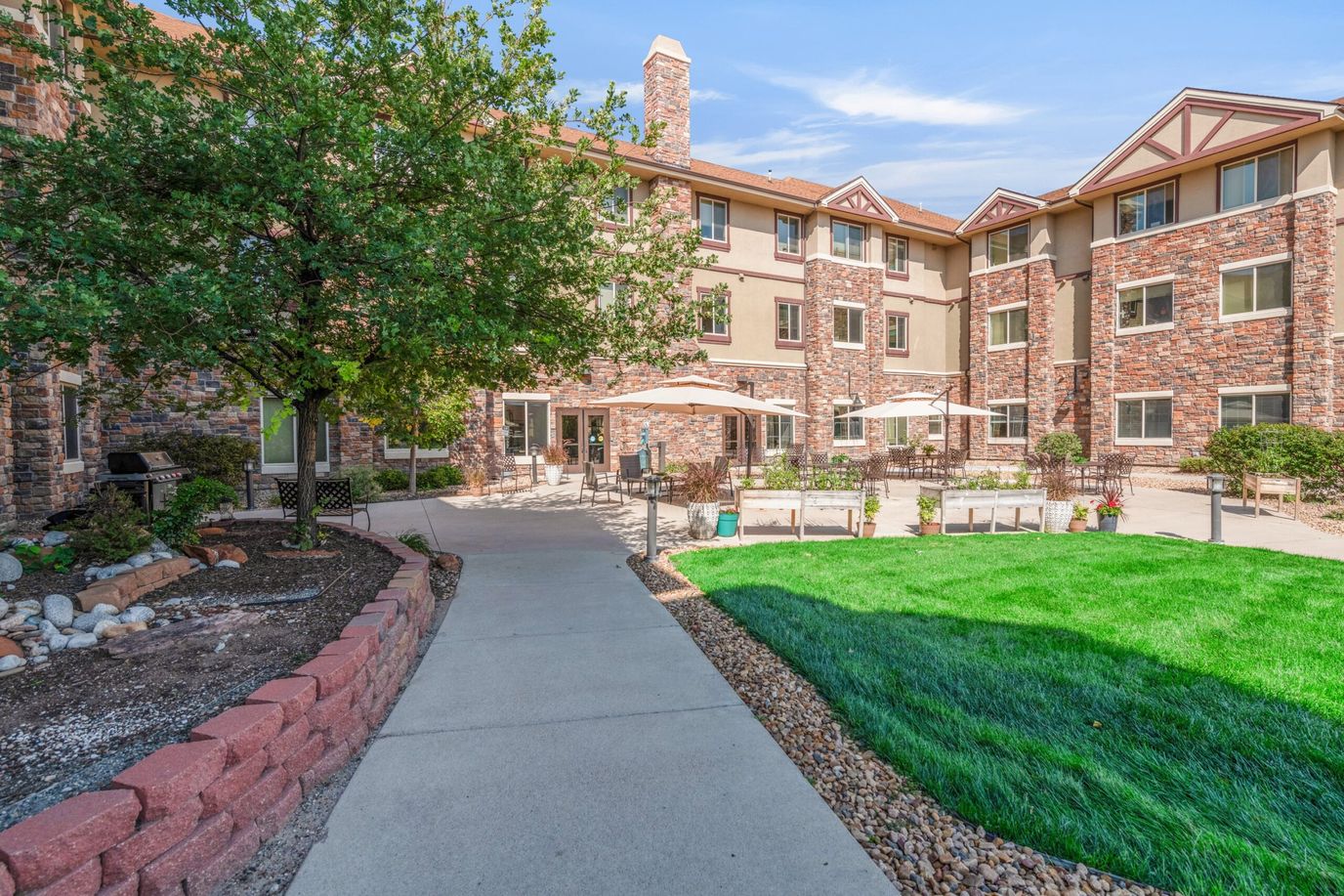 Exterior view of the assisted living facility with a garden