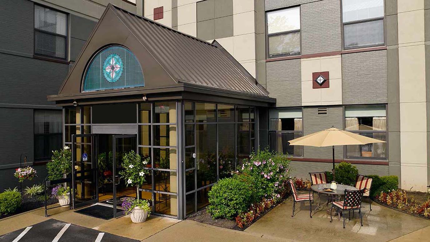 Exterior view of the facility entrance and outdoor seating